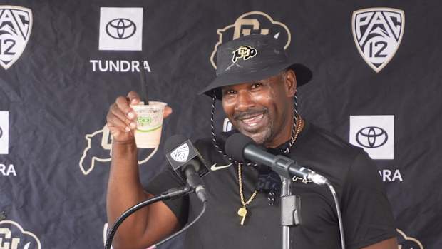 Coach Andre Hart at the podium at CU